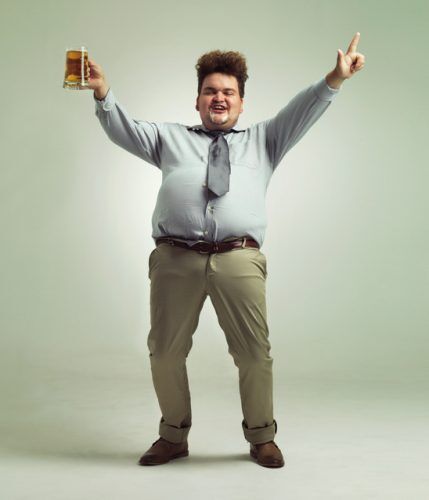 overweight man celebrating while holding a pint of beer