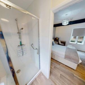 drug and alcohol rehab bedroom with ensuite shower toilet and bed