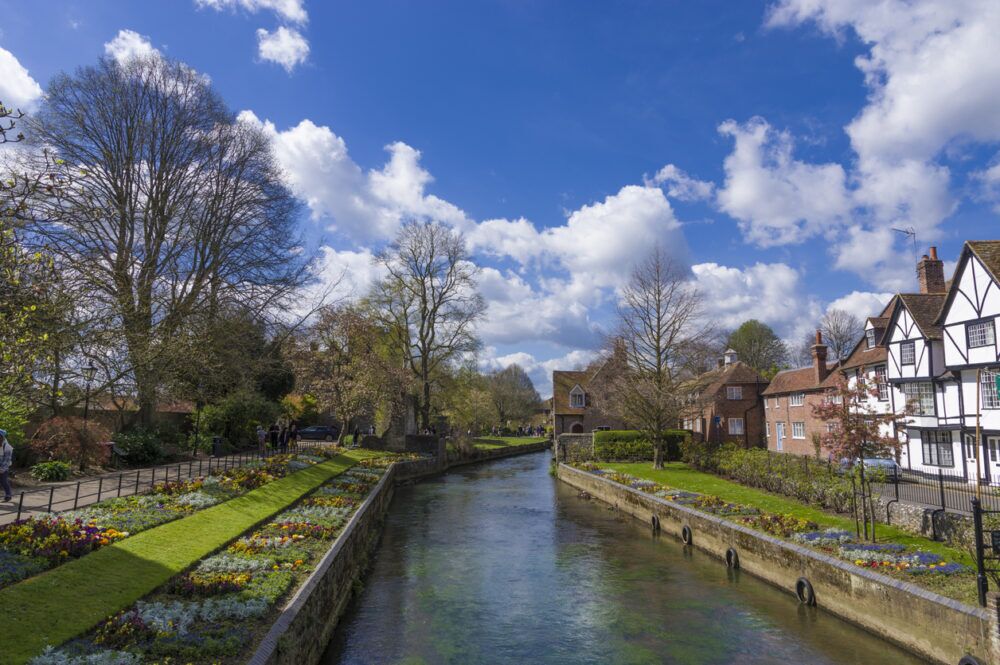 Alcohol Rehab Bedworth - a photograph of a river with grass on either side and residential housing to the right.