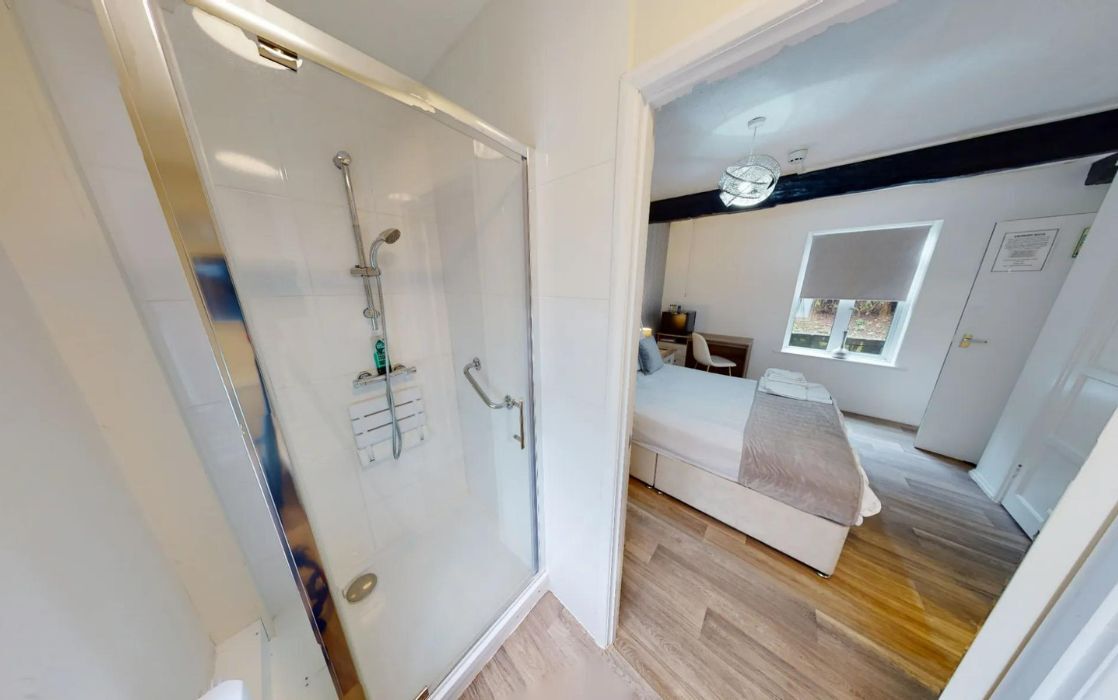 drug and alcohol rehab bedroom with ensuite shower toilet and bed
