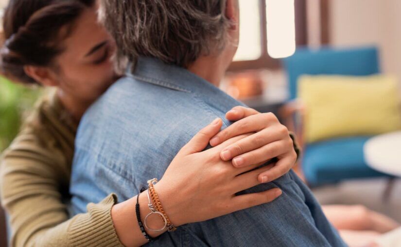 Person hugging a drunk angry spouse