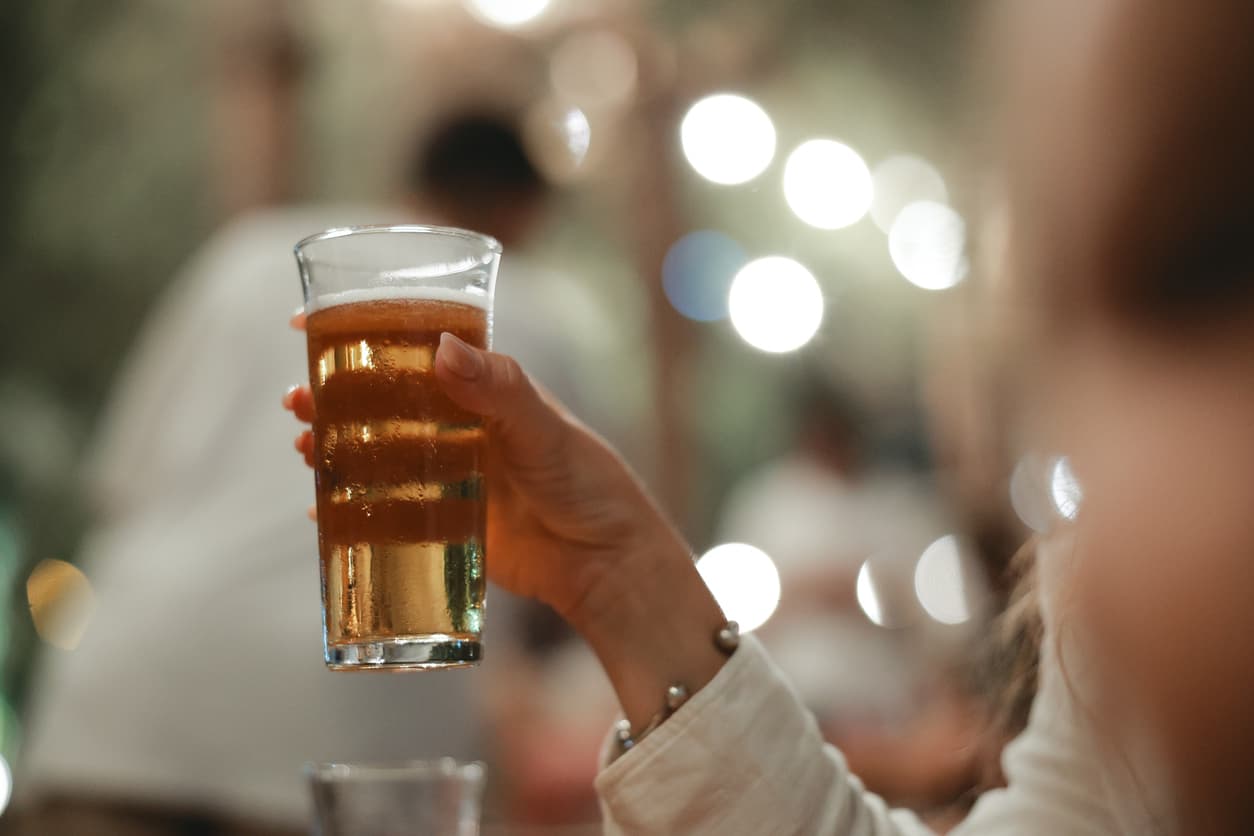 Person drinking a pint in cold weather