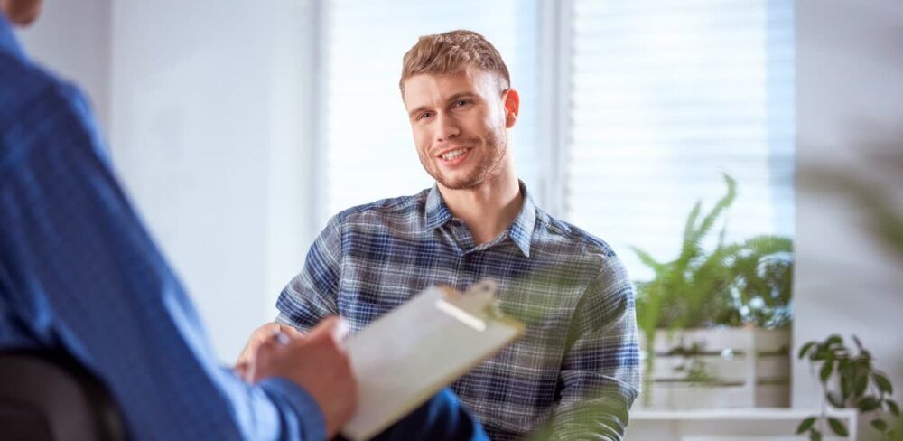 Man in therapy session in drug and alcohol rehab Dunstable